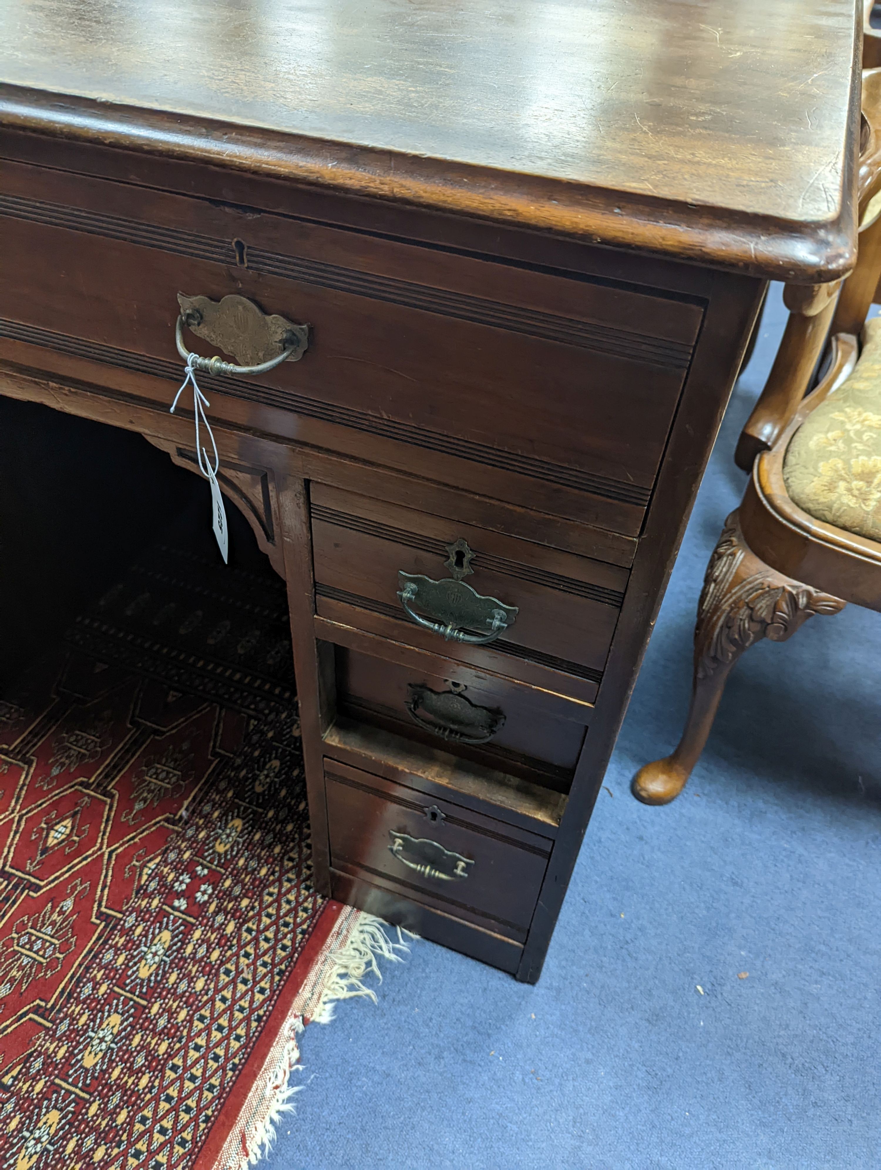 A late Victorian mahogany kneehole desk, length 107cm, height 80cm